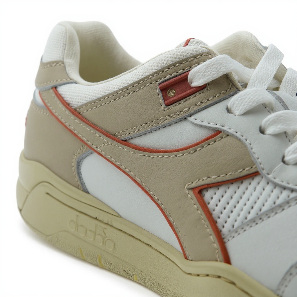 Primer plano detallado de la deportiva DIADORA beig, mostrando la combinación de piel, tejido técnico y la suela, resaltando su construcción de calidad.