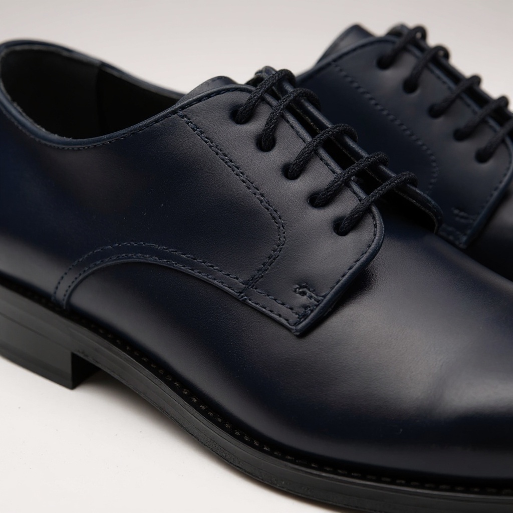 Detalle de los zapatos CALCE blucher azul, mostrando la textura de la piel ANTIC y la suela SPAY.